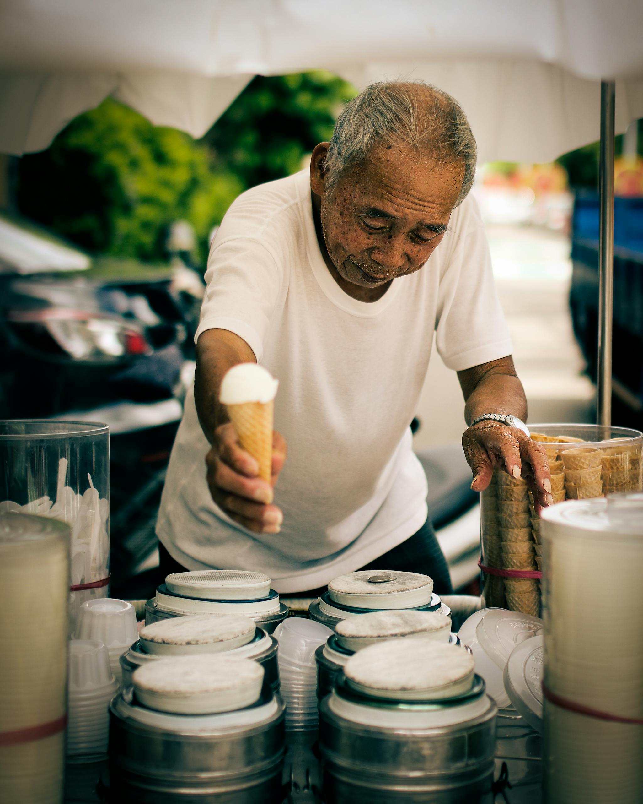 Senior man selling ice cream on a street in Taiwan. Capturing local culture and tradition.